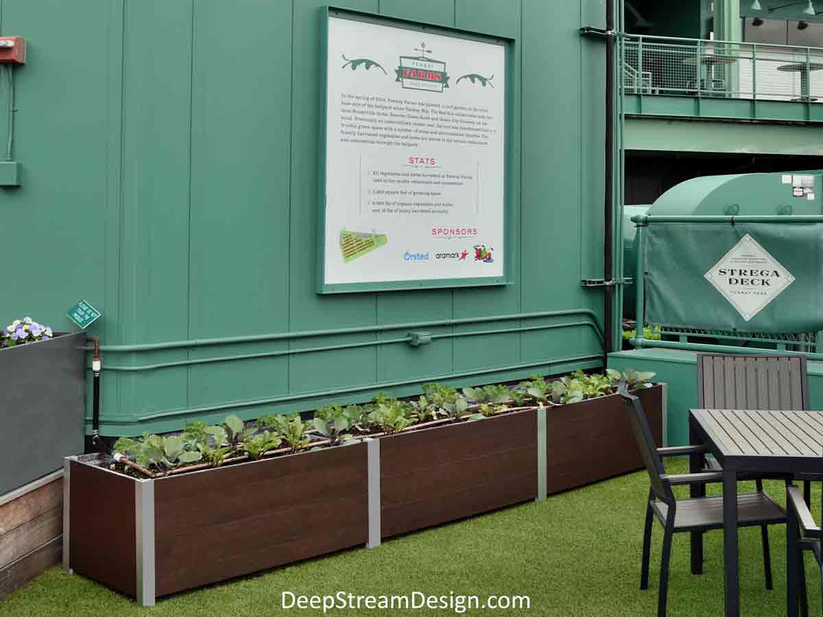 Large Long Wood Garden Planters in  Ipe Brown recycled plastic lumber with food safe LLDPE liners growing produce set among the tables of a farm-to-table restaurant's outdoor roof terrace dining area.