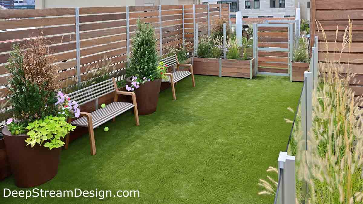 Looking inside a roof top dog park, complete with plants and benches, created by Large Wood Garden Planters anchoring gates, glass, and wood screen walls.