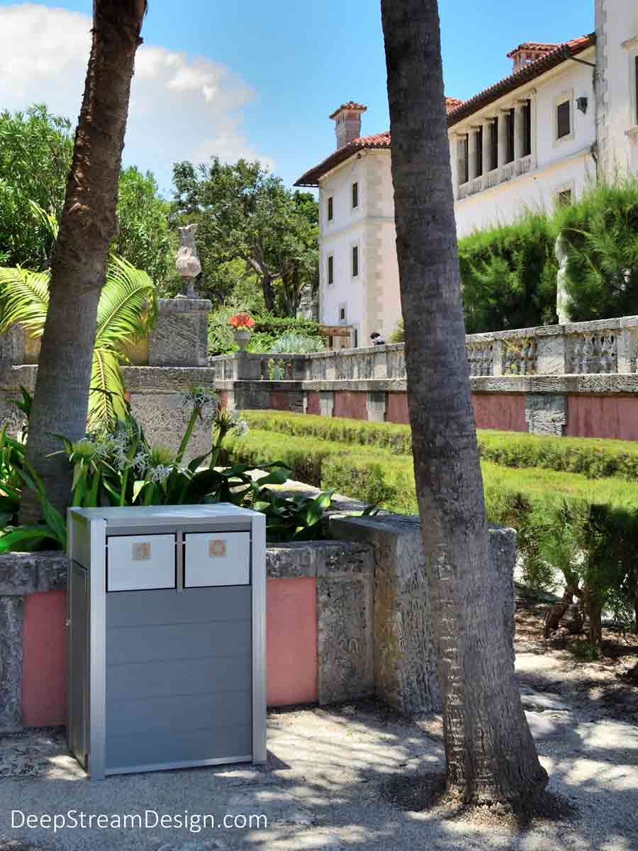 Looking appropriate in this classical setting with Vizcaya, a Mediterranean Revival Mansion on Biscayne Bay in the background, the Oahu Commercial Combined Recycling and Trash Receptacle stands up to the saltwater environment because it is crafted with Dark Gray-colored no-maintenance recycled plastic lumber, 316 stainless steel lid, marine aluminum push flaps, and ergonomic door to remove the leakproof 21-gallon inner bins.