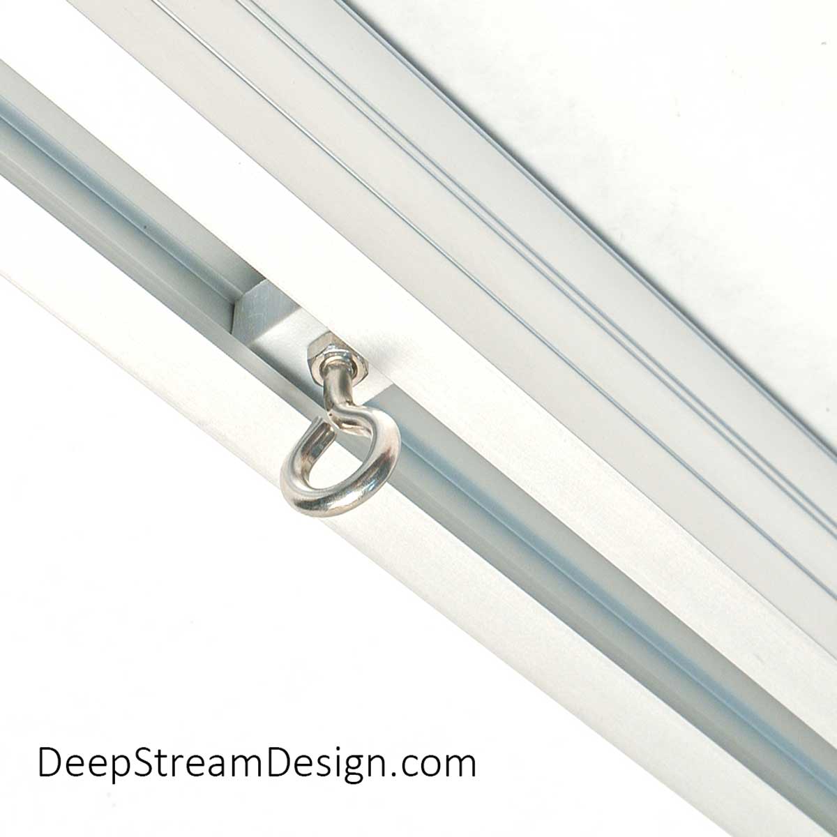 A studio photo shows how a slippery HDPE plastic block with a 316-stainless steel mini eyebolt makes the perfect track slide for curtains when uses used inside the flawless anodized panel acceptance slot designed into all the Audubon Structural Architectural Aluminum Frame System primary extrusions.